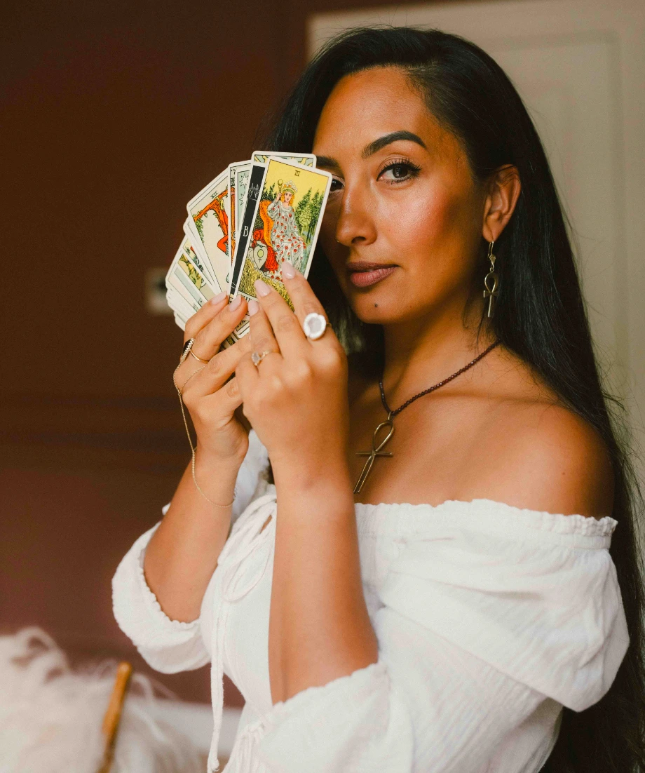 Woman holding tarot cards